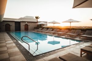 Rooftop pool at sunset with lounge chairs