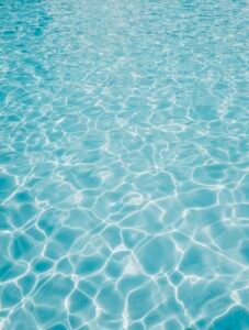 Crystal clear rippling pool water surface