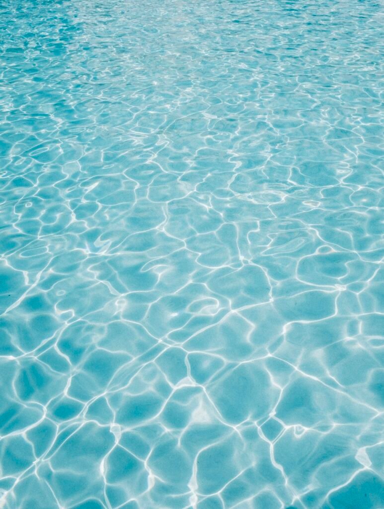 Crystal clear rippling pool water surface