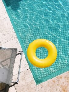 Yellow pool float on turquoise tile pool